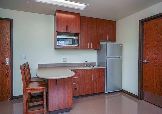 Each room is equipped with a kitchenette that includes a refrigerator, microwave and two bar stools.